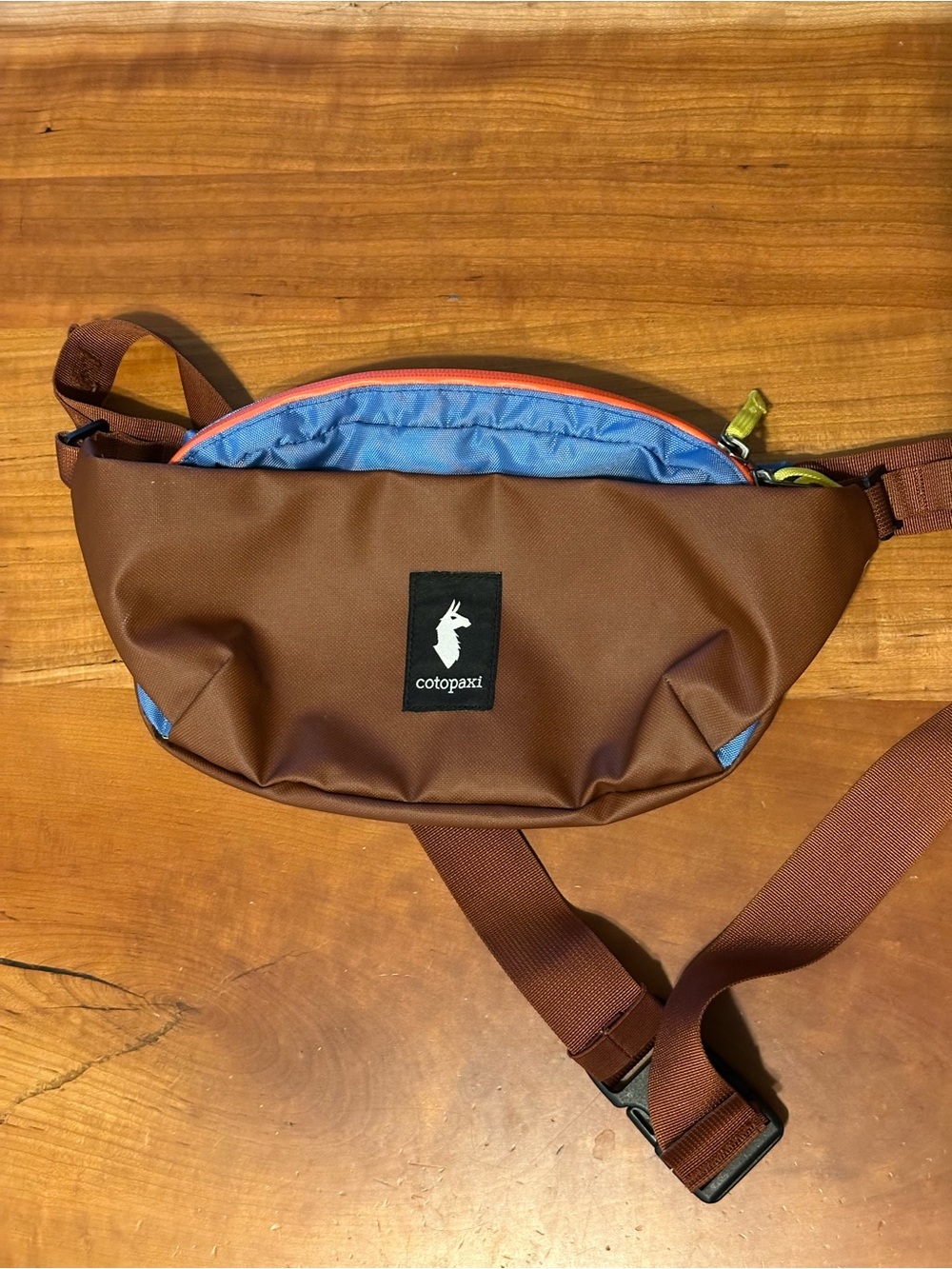 cotopaxi brown belt bag with blue trim